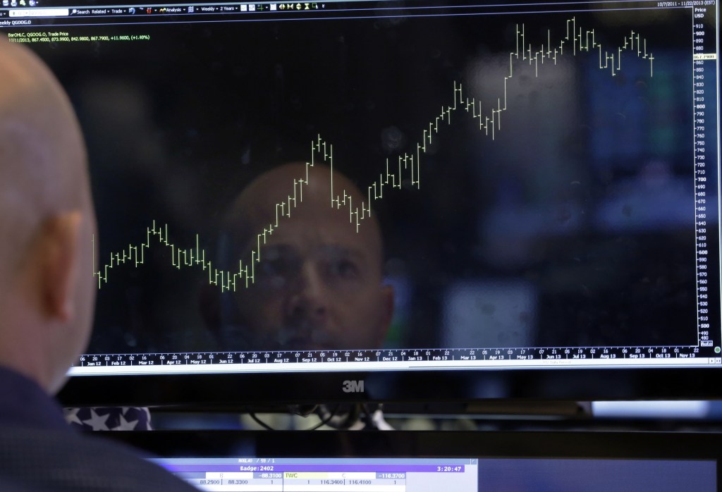 Specialist Jay Woods is reflected in a screen at his post on the floor of the New York Stock Exchange. Stocks are on track for their best annual performance in a decade, with all 10 industry groups in the Standard & Poorís 500 index set to finish 2013 with a gain of 10 percent or more.