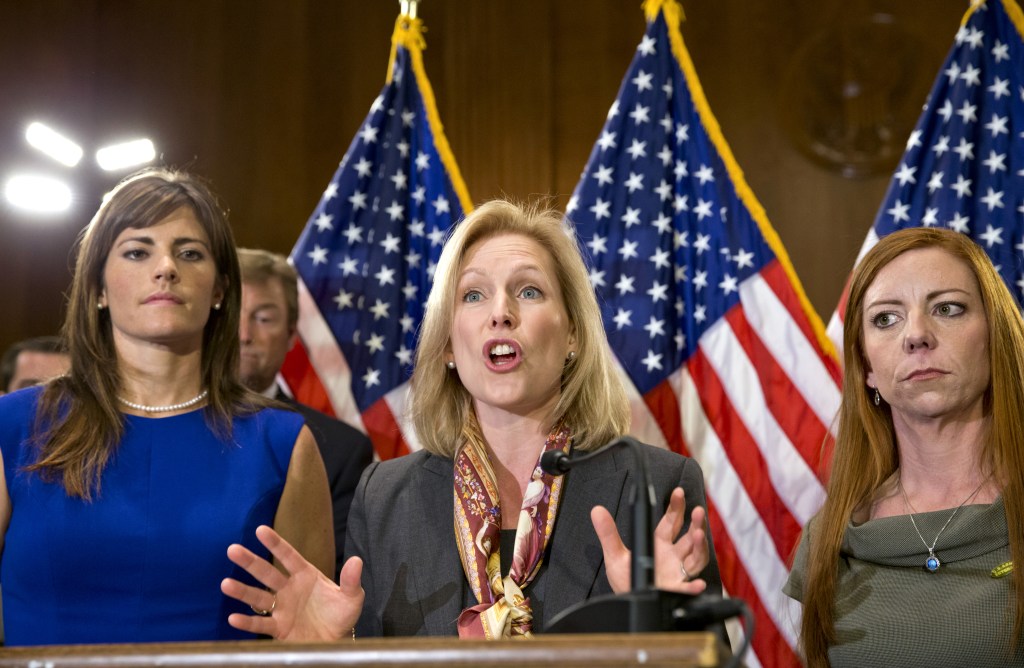 Sen. Kirsten Gillibrand, D-N.Y., center, flanked by victims of sexual abuse in the military, speaks at a news conference Tuesday about her proposed changes to how the military deals with alleged crimes.