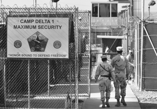 ENTERING GUANTANAMO BAY PRISON: U.S. military guards walk within Camp Delta military-run prison, at the Guantanamo Bay U.S. Naval Base, Cuba. Some detainees have been held since shortly after 9/11.