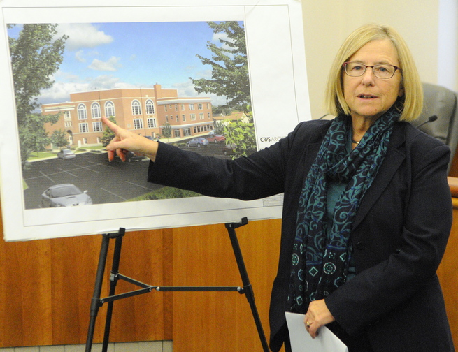 Cynthia Taylor, president of Housing Initiatives of New England Corp., talks about plans to renovate the old Cony flatiron building into apartments during a news conference Friday at Augusta City Center.