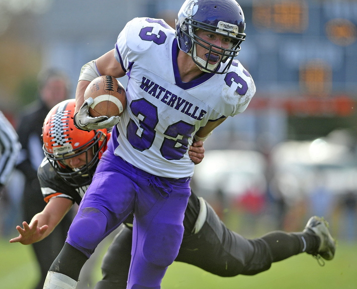 Staff photo by Michael G. Seamans Waterville Senior High School's Troy Gurski, 33, breaks a tackle against Winslow High School in Winslow on Saturday. Winslow defeated Waterville 49-12.