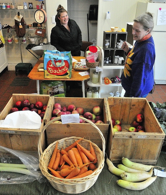 Local FOOD: Owner Marcina Johnson, left, chats with customer Sandy Wachholz recently at Founding Farmers Community Market in Gardiner, which sells locally grown food.