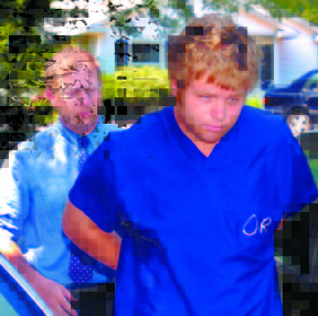convicted killer: Maine State Police Detective Dean Jackson escorts John A. Okie. into the Lincoln County Sheriff’s Office Tuesday in Wiscasset. Okie has been convicted with the killing of Alexandra Mills, 19, at her home in Wayne, and the stabbing death of his father, John S. Okie Sr., both in July 2007.
