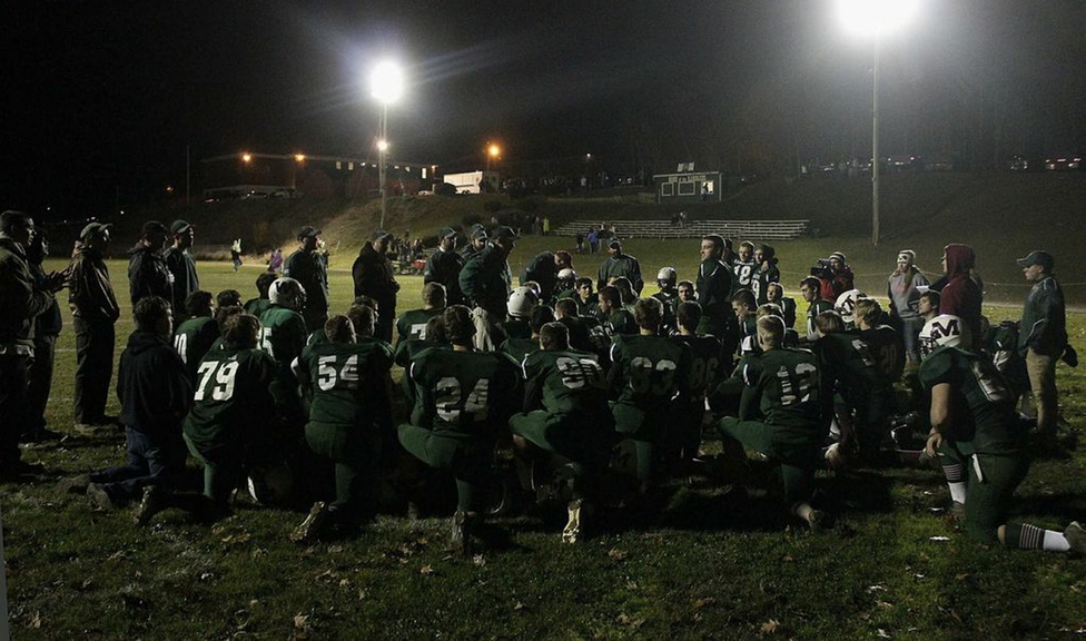 TWO COMMUNITIES, TOGETHER: The Winthrop/Monmouth football team huddles in the end zone after their playoff loss to Dirigo earlier this month. Players from two towns came together to form the new team, which finish the season 9-1.