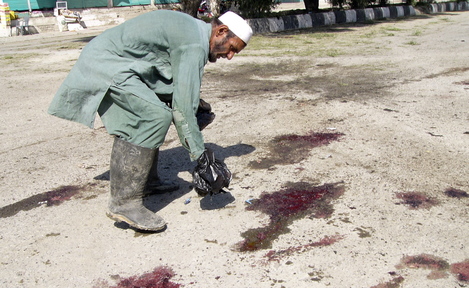 An Afghan man inspects the scene of a suicide bombing in Khost province in October 2012 that killed three NATO soldiers, an Afghan interpreter and at least nine civilians. The State Department rejects the claims by many interpreters who helped U.S. forces that they face “serious threats” in Afghanistan.