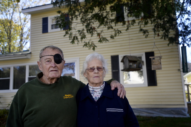Pauline and Cedric Long stand outside their Camden home Oct. 24. Many people have felt moved by the Longs’ story to help the elderly couple, who were financially exploited by their daughter-in-law and son. Gary and Deborah Long got $164,000 that put his parents’ home on the line.