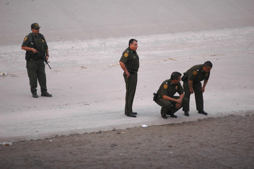 In this June 7, 2010, photo, border patrol agents examine the area near where 14-year-old Mexican youth Sergio Adrian Hernandez Huereca was killed, allegedly shot by a U.S. Border Patrol agent after a confrontation under the Paso Del Norte border bridge in Ciudad Juarez, Mexico.