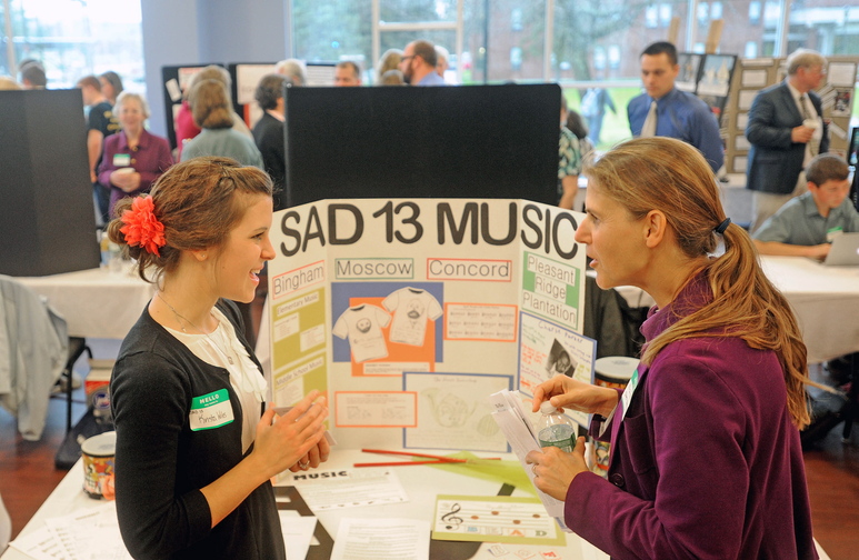 education gathering: Krista Wilser, left, a music teacher with Bingham-based School Administration District 13, speaks with Nichi Farnham, with the State Board of Education during a Kennebec Valley area high school expo at Thomas College on Friday morning.
