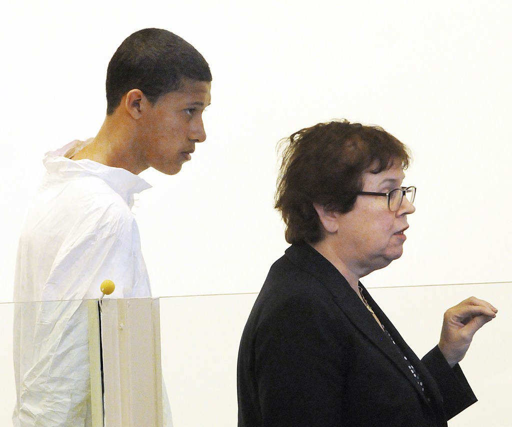 In this Oct. 23, 2013, file photo, Philip Chism, 14, stands during his arraignment for the death of Danvers High School teacher Colleen Ritzer, as his attorney Denise Regan speaks on his behalf in Salem District Court in Salem, Mass. In an indictment returned Thursday, Nov. 21, 2013, Chism was charged with sexually assaulting and killing Ritzer, and stealing her credit cards and iPhone.