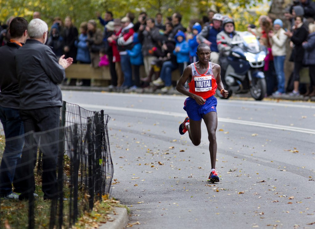 Geoffrey Mutai of Kenya rounds a corner in Central Park on his way to winning the New York Marathon Sunday, Nov. 3, 2013. The New York City Marathon returned after a one-year absence with big crowds and heightened security.