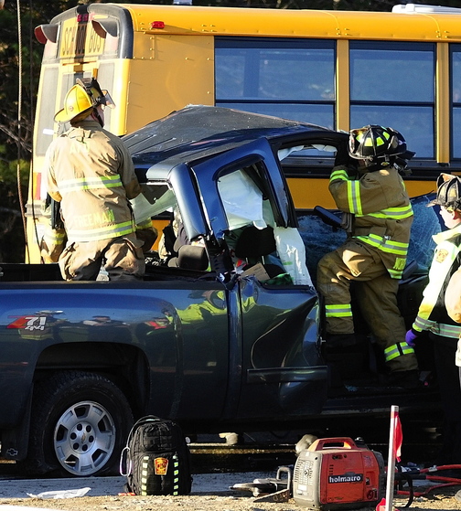 Emergency crews remove the roof: of a pickup truck as they work to free a driver at the scene of a crash involving an Augusta school bus Tuesday on Riverside Drive, just south of Stevens Road, in Augusta.