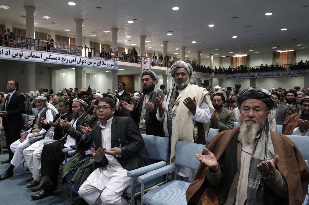Members of the Afghan national consultative council known as the Loya Jirga pray Sunday during the last day of the assembly in Kabul, Afghanistan.