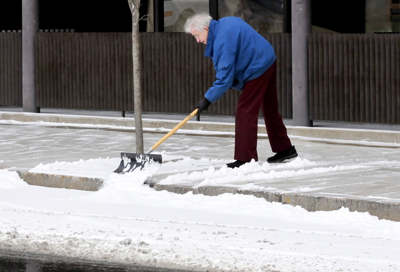 FIRST SNOW: The first snow fell on central Maine on Tuesday, bringing out snow shovels, plows and worry for road conditions. Gerald Giroux did his part to clear sidewalks in front of Berry’s Stationers on Main Street in Waterville.