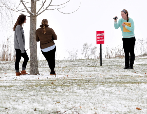 WINTER: Colby College students work on a class project out in the snow near barely frozen Johnson Pond on Tuesday. Katherine Mackey shots the photos of her friends Eleanor Ozburn, left, and Sarah Shimer.