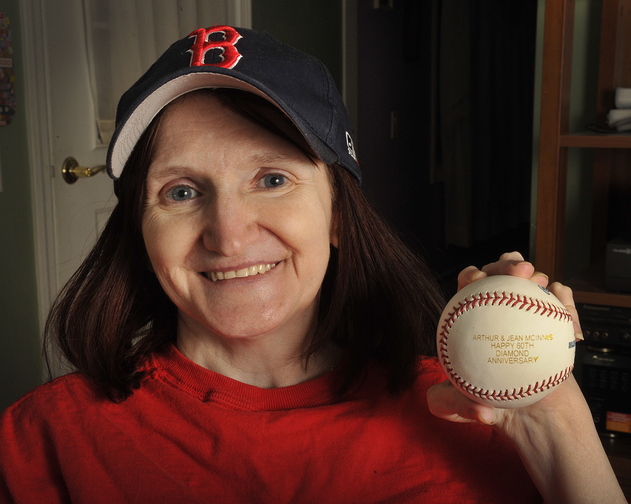Kathy McInnis-Misenor of Saco holds a baseball given to her mother and father by the Boston Red Sox on their 60th “diamond” wedding anniversary.