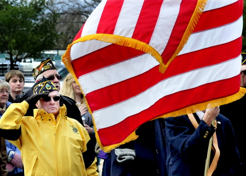 VETERANS SALUTE: Veteran Reginald Joler salutes during a Veterans Day service following a parade in Waterville on Monday, Nov. 11, 2013.