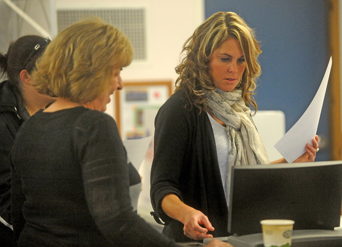 Lakefront vote: Melissa Tenney casts her ballot after voting in the China local election at the China Town Office on Tuesday. Voters turned out to decide whether to buy lakefront property and to elect town officials.