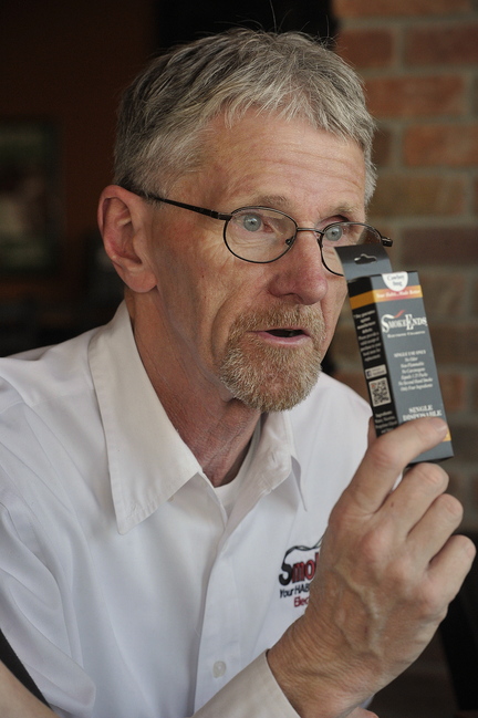 Steve Gorham touts the benefits of e-cigarettes. His wife, Carrie, started the distributorship three years ago after throwing her last seven cigarettes into a mud puddle.