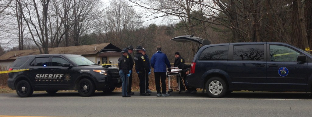 Suspicious Death: Officials prepare to remove the body of a man found dead Friday morning in a residence on U.S. Route 201 in Vassalboro.