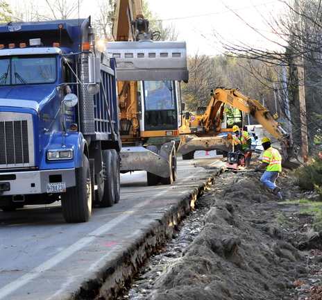 WORK IN PROGRESS: Subcontractors bury recently installed natural gas pipeline along the Middle Road in Fairfield on Tuesday.