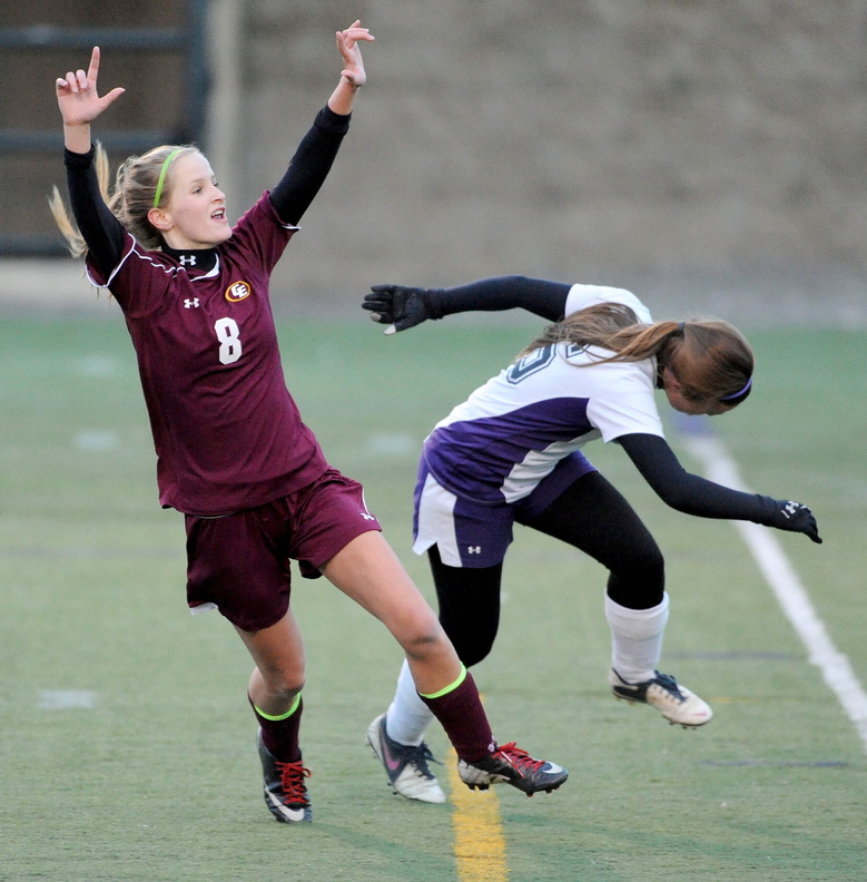 GOAL: Cape Elizabeth’s Katherine Breed, left, celebrates her first half goal as Waterville Senior High School’s Jayme Saulter tries to defend in the Class B state championship game Saturday at Hampden Academy.