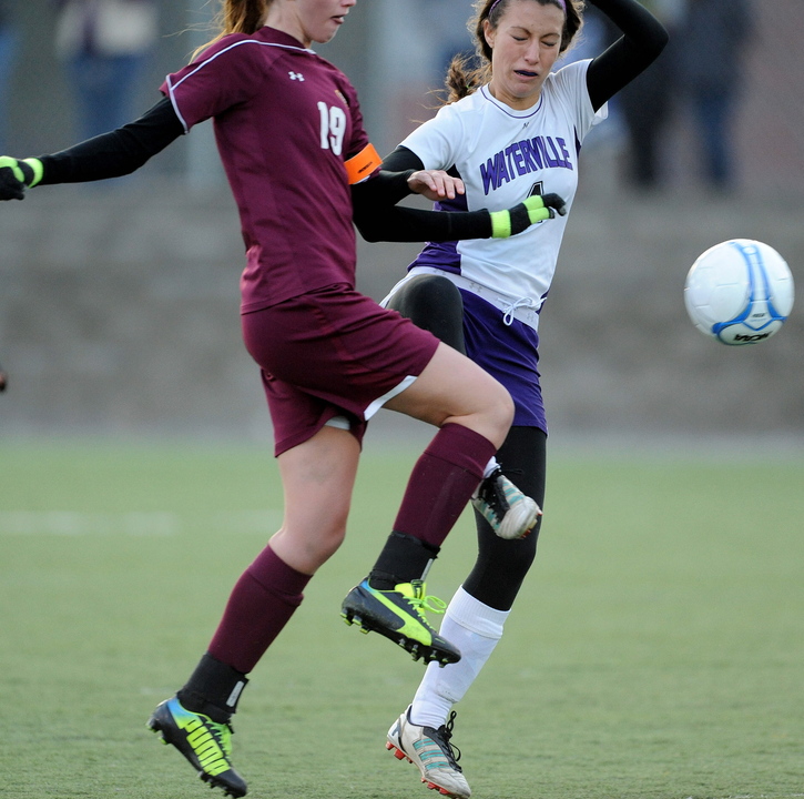 BATTLE FOR THE BALL: Cape Elizabeth’s Addison Wood, left, battles for the ball with Waterville Senior High School’s Emily Dufour in the first half in the Class B state championship game at Hampden Academy on Saturday. Cape Elizabeth defeated Waterville in a shoot-out.