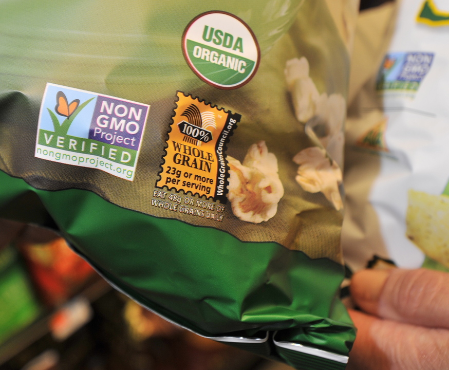 A label on a snack item indicates it as certified organic and not containing any GMOs or genetically modified organisms, at a Portland supermarket, Wednesday, July 24, 2013.
