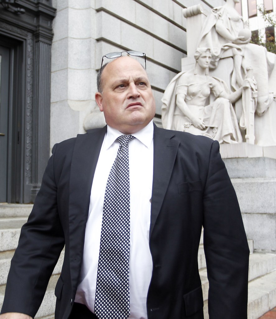 Ralph M. Mariano exits federal court for his sentencing in a Navy kickback scheme Friday in Providence, R.I. Mariano pleaded guilty in May to conspiracy, theft of government property and tax evasion and was sentenced Friday to 10 years in prison.