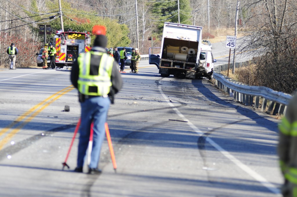 Emergency crews work at the scene of a collision between a conversion van and a panel truck near intersection of U.S. Route 202 and Royal Street on Thursday November 21, 2013 in Winthrop. State Police troopers were using surveying equipment as part of their reconstructing the accident scene.