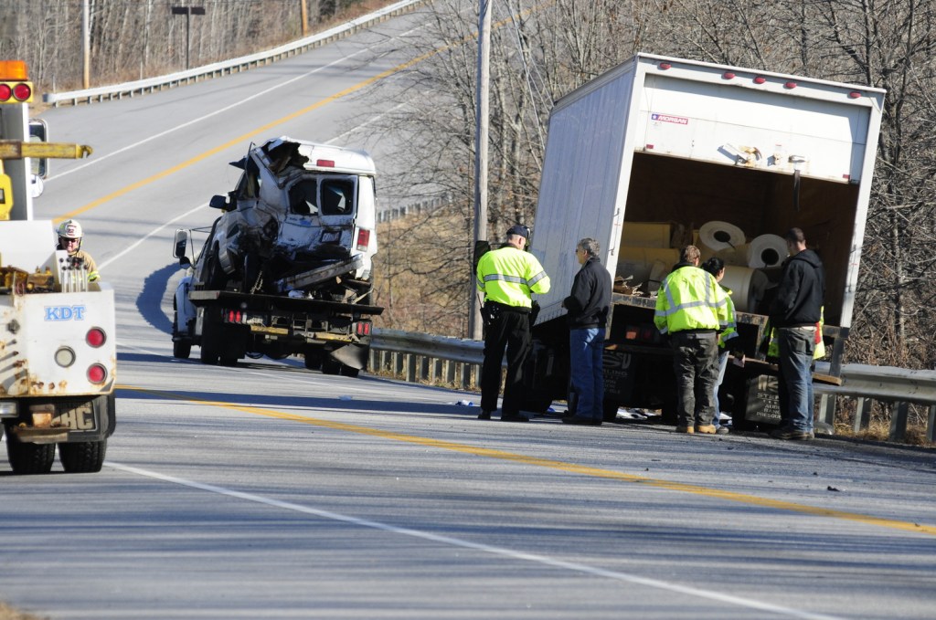 Emergency crews work at the scene of a collision between a conversion van and a panel truck near intersection of U.S. Route 202 and Royal Street on Thursday November 21, 2013 in Winthrop. State Police troopers were using surveying equipment as part of their reconstructing the accident scene.