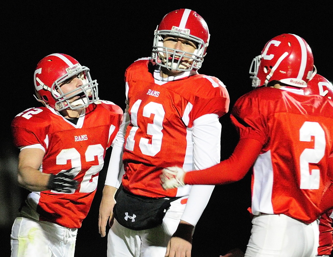 ONE MORE STEP: Cony quarterback Ben Lucas, center, is congratulated by teammates John Bennett, left, and Mitchell Bonnefant after scoring a touchdown in a game earlier this season. Lucas and the Rams will face Kennebunk in the Class B state championship game tonight at the University of Maine in Orono.