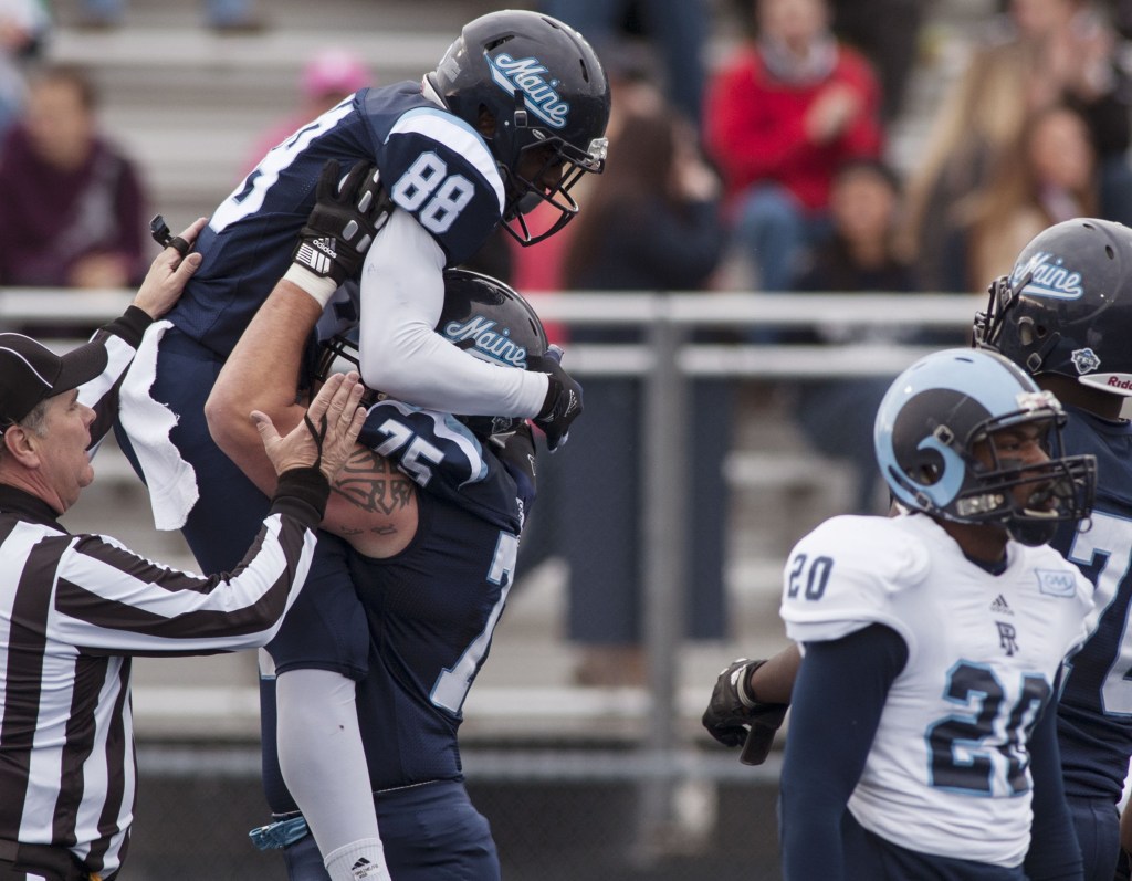 Maine wide receiver DamarrAultmann, 88, celebrates with teammate Joseph Hook after scoring against Rhode Island in the first half on Saturday at Orono. UMaine won 4-0 to clinch the Colonial Athletic Association title.