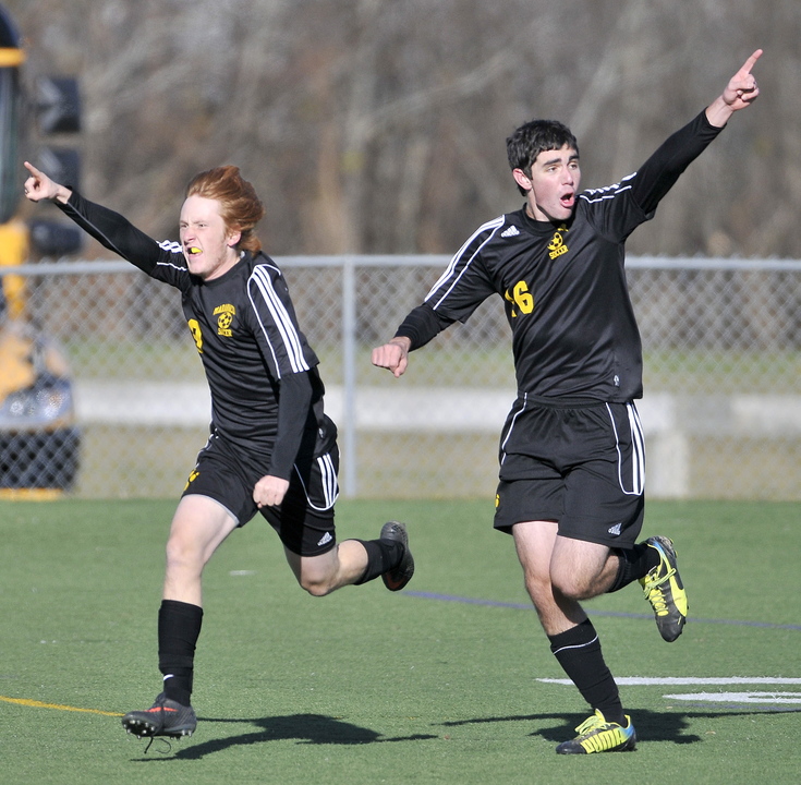 Staff photo by Michael G. Seamans Maranacook High School's Alex Tooth, 9, right, celebrates his first half goal against Madawaska with teammate Tyler Lang, 16, right, in the Class C State Championship game at Hampden Academy on Saturday. Maranacook defatted Madawaska 2-0.
