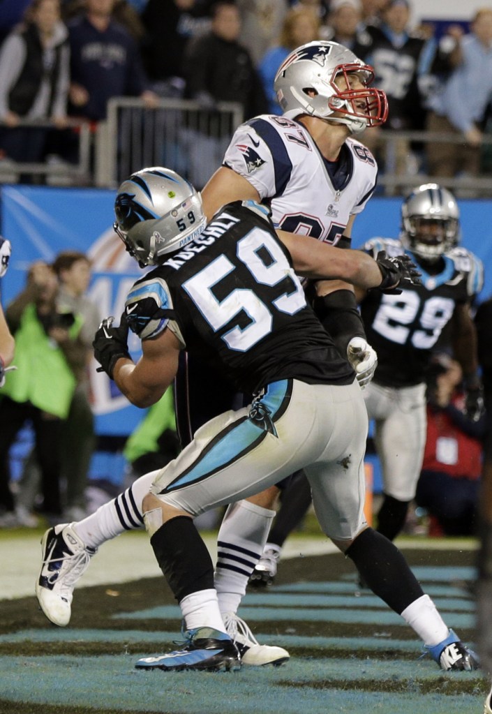 THE PLAY: Carolina’s Luke Kuechly (59) hits New England’s Rob Gronkowski (87) on the final play of the Patriots’ 24-20 loss to the Panthers on Monday in Charlotte, N.C.
