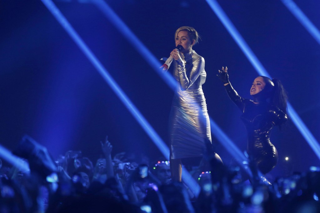 Miley Cyrus, left, and a dancer perform at the 2013 MTV Europe Music Awards in Amsterdam, Netherlands, Sunday, Nov. 10, 2013.