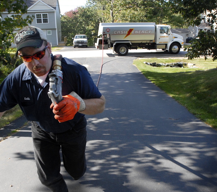 Keith Franklin of Cash Energy delivers heating oil recently to a home in Old Orchard Beach. The state is still waiting for word on what kind of federal fuel assistance Mainers can expect for the coming winter.