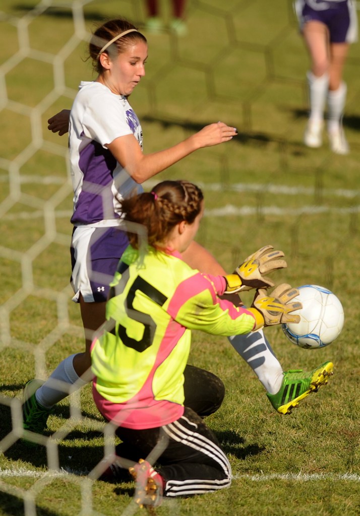 GOAL: Waterville Senior High School’s Lydia Roy scores a goal against on Caribou High School goalie Morgan Outing during the Panthers’ 6-0 win in the Eastern B semifinals Saturday in Waterville.