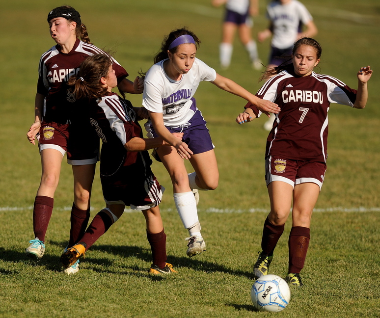 A BATTLE FOR THE BALL: Waterville Senior High School’s Pilar Elias (23) battles through Caribou High School defenders, Erin Patton (9) far left, Eileen Patton, left center, and Emma Jandreau, right, in the first half in the Class B East semi-finals game in Waterville on Saturday. Waterville defeated Caribou 6-0.