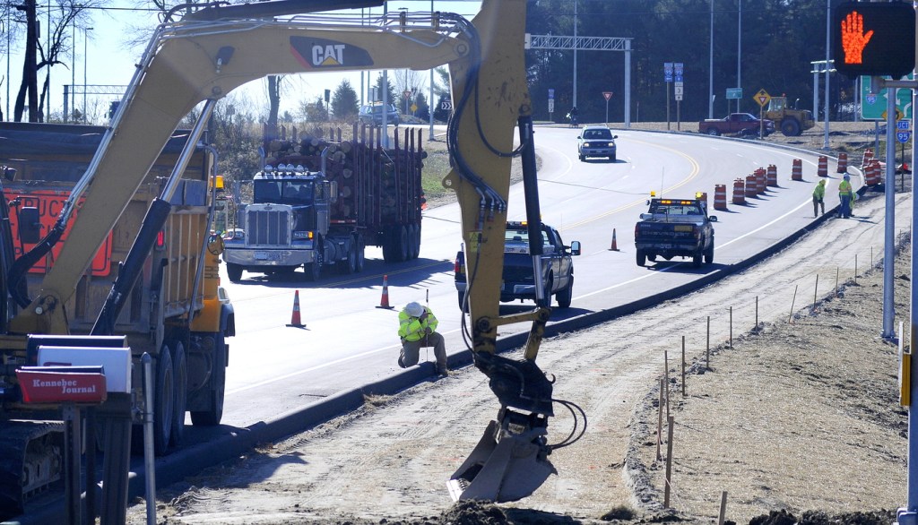 EXIT: Maine Department of Transportation engineer Matt Swindells stakes a sidewalk Monday near the entrance to the MaineGeneral Medical Center’s new hospital in Augusta.