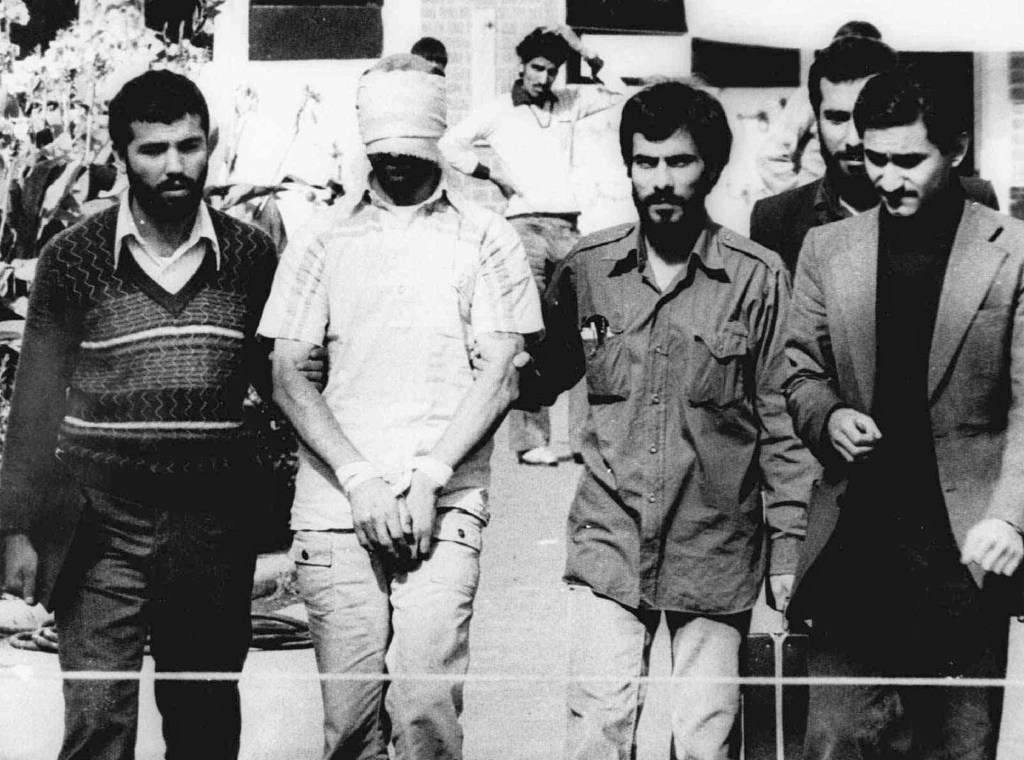 In this Nov. 9, 1979, photo, one of the hostages being held at the U.S. Embassy in Tehran is displayed to the crowd, blindfolded and with his hands bound, outside the embassy.