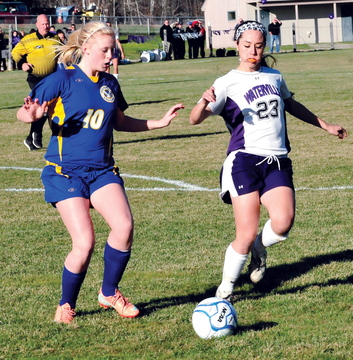 FIRST GOAL: Waterville’s Pilar Elias, right, passes the ball as Hermon’s Sierra Snow puts on pressures during Waterville’s 2-1 win in the Eastern B regional final Wednesday in Waterville.