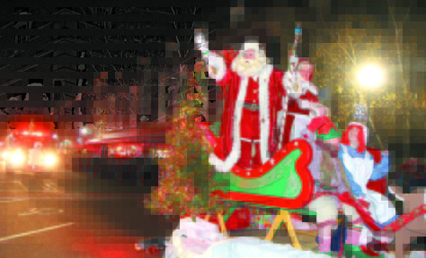 File photo by Jeff Pouland HERE COMES SANTA CLAUS: Santa and Mrs. Claus arrive in downtown Waterville during the 7th Annual Parade of Lights last year.