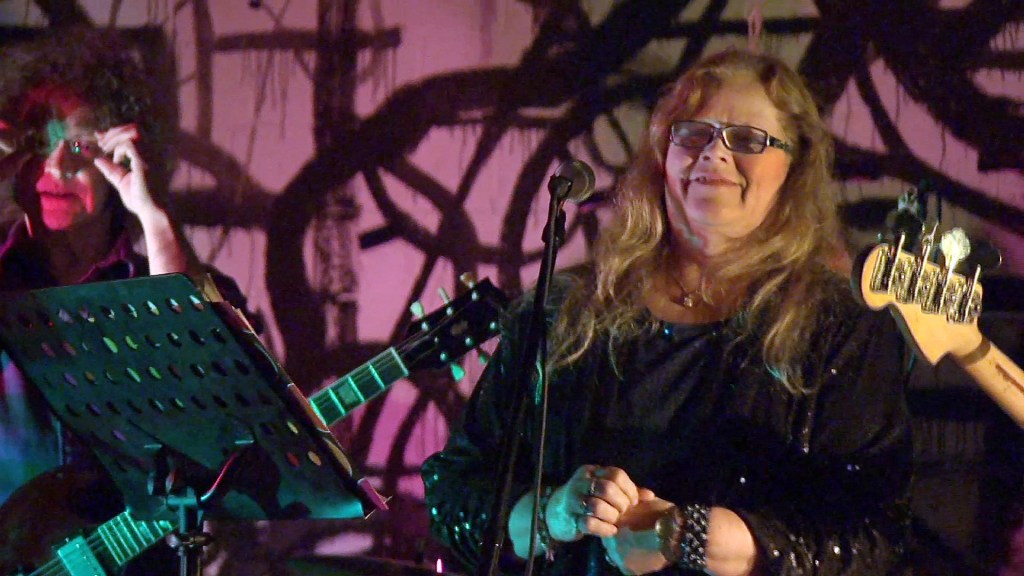 In this image taken from video Nov. 6, 2013, Dot Semprini as seen with the Dot Wiggin Band at the 285 Kent club in Brooklyn, N.Y. Semprini was one of the original members of The Shaggs, an obscure female band from Fremont, N.H. Now at 65 she has returned to the stage to sing to her loyal fans.