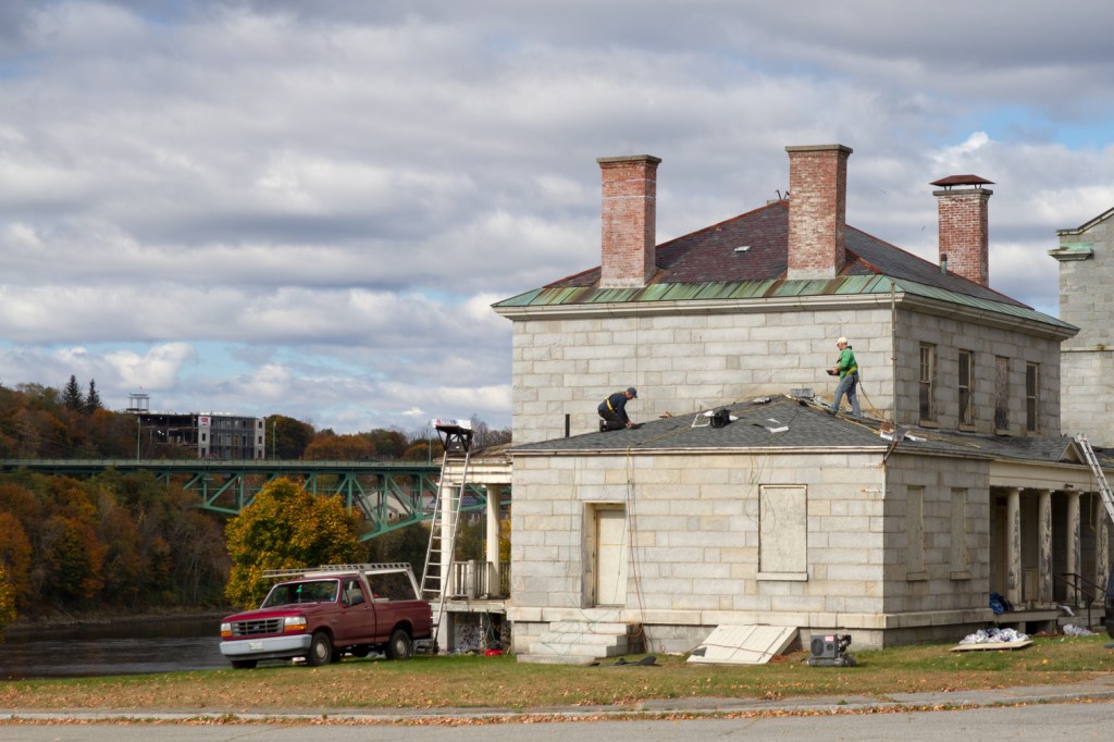 High Maintenance: Workers replace the roof on the South Burleigh building at the Kennebec Arsenal.