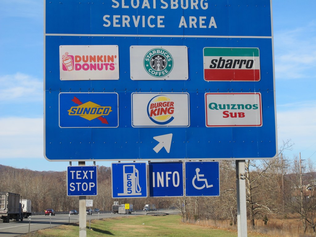 A new “text stop” notification is seen on a sign for a service area on the New York State Thruway in Sloatsburg, N.Y.. A state crackdown on texting while driving includes designating many pull-off areas as text stops.