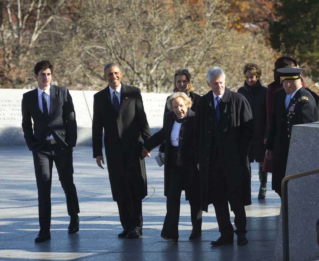President Barack Obama and former President Bill Clinton hold hands with Ethel Kennedy, widow of Robert F. Kennedy, as they walk with members of the Kennedy family for a wreath laying ceremony in honor of President John F. Kennedy on Wednesday at the JFK gravesite at Arlington National Cemetery in Arlington, Va. On the far left is John Schlossberg, JFK’s grandson.
