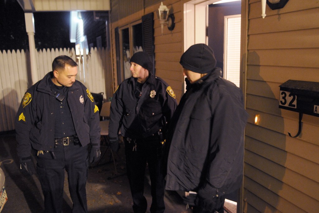 Augusta Police patrolmen Sgt. Vincente Morris, left, Officer Carly Smith and Officer Laura Drouin confer Wednesday evening outside of an apartment at 32 Crosby Street in Augusta after a deceased woman was discovered inside the first floor unit just after 8 p.m. A man also found inside the apartment was transported to the hospital with injuries, police said. State Police detectives from the Major Crimes Unit took charge of the investigation that authorities characterized as a suspicious death. Chief Medical Examiner Dr. Margaret Greenwald arrived at midnight to determine a cause of death, according to authorities.