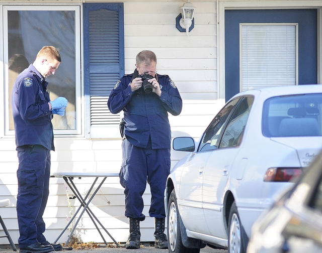 Investigators continue to work at the scene of a suspicious death on Thursday at 32 Crosby St. in Augusta