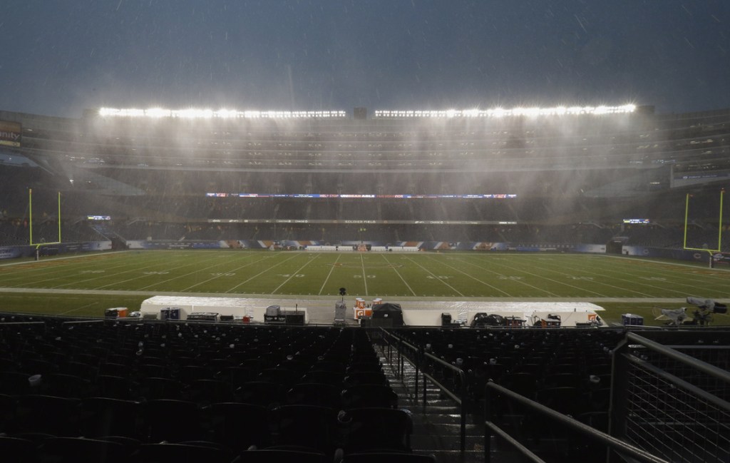 Heavy rain falls as play is suspended during the first half of the Bears-Ravens football game Sunday in Chicago.