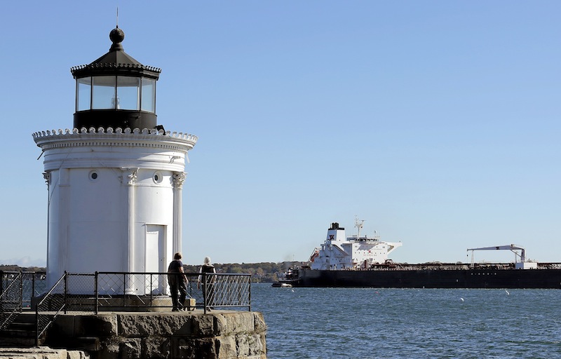 In this Oct. 18 file photo, the oil tanker Gagnes Spirit jockeys for position with the help of a couple of tugboats at the Portland Pipeline Corporation dock just behind Bug Light in South Portland. If South Portland voters approve the controversial Waterfront Protection Ordinance on the city ballot Tuesday, the law will likely end up in court, lawyers and city officials say.